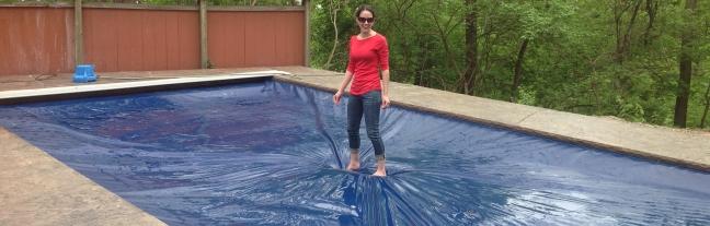 lady walking on automatic pool cover